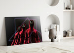 Squid Game close-up showing three scarlet guards with circle triangle square masks