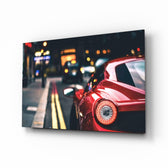 Ferraris Red glass wall art displayed above a leather chesterfield in a brick-walled man cave with reclaimed-wood console and matte-black floor lamp