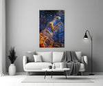 Space close-up showing rust-colored Pillars of Creation among indigo stars