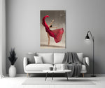 Ballerina close-up showing dancer en pointe with crimson silk swirling above arched back