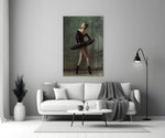Ballerina close-up showing black-tutu dancer in profile en pointe