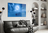 Moon and Boat glass wall art styled above a bed in a bedroom