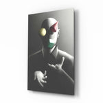Juggler glass wall art displayed above a charcoal sofa in a slate-walled office lounge with steel desk and matte-black shelving