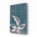 Leaves glass wall art displayed above a marble vanity in a slate-blue bathroom with brushed-brass faucet and stoneware tray