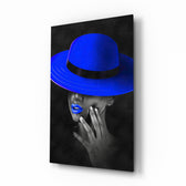 Blue Hat glass wall art displayed above a charcoal velvet bed in a slate bedroom with brushed-brass sconces and cobalt velvet bench