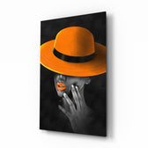 Orange Hat glass wall art displayed above a charcoal velvet bed in a slate bedroom with brushed-brass sconces and tangerine velvet bench