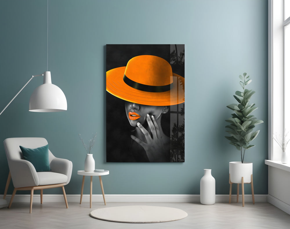 Orange Hat glass wall art styled above a bed in a bedroom