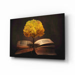 Tree in My Mind glass wall art displayed above a leather chesterfield in a mahogany-paneled library with brass desk lamp and antique books