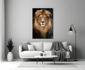 Lion close-up showing mane-haloed head with amber eyes against onyx void