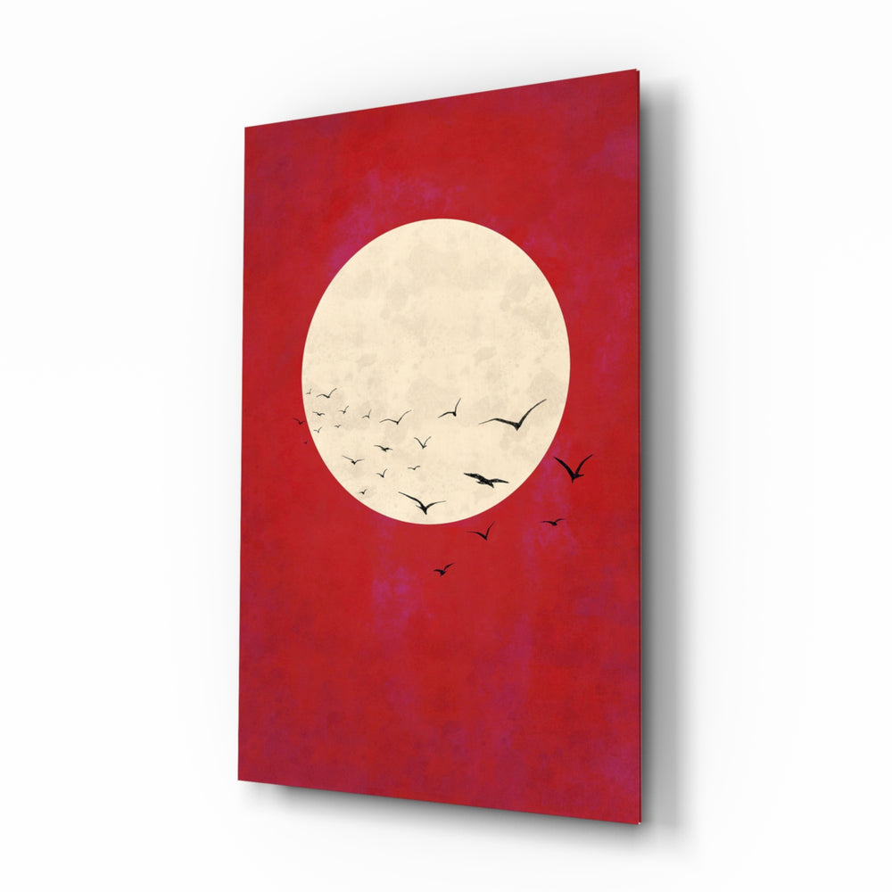 Fly from the Moon glass wall art displayed above a charcoal sofa in a crimson-painted lounge with reclaimed-wood console and matte-black floor lamp