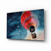 Baloon to the Moon glass wall art displayed above a linen bed in a midnight-blue kids room with rattan nightstands and brushed-brass sconces