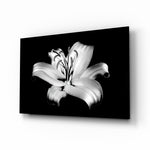 Lilies glass wall art displayed above a charcoal velvet bed in a slate bedroom with brushed-brass sconces and onyx nightstands