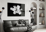Lilies glass wall art styled above a bed in a bedroom