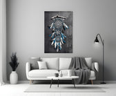 Dreamcatcher close-up showing cobalt feathers and silver beads on driftwood branch