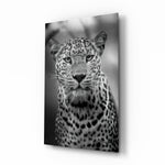 Leopard glass wall art displayed beside a leather chesterfield in a slate-walled man cave with reclaimed-wood console and matte-black floor lamp