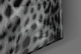 Leopard artwork anchoring a wall with dark primal palette