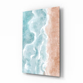 Beach glass wall art displayed above a marble vanity in a coral-walled bathroom with brushed-brass faucet and stoneware tray