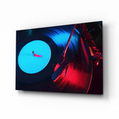 Gramophone glass wall art displayed above a black leather sofa in a neon-lit gaming lounge with brass arc lamp and matte-black console