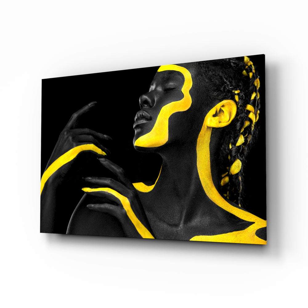 Yellow Woman glass wall art displayed above a velvet bed in a moody bedroom with rattan nightstands and brushed-brass sconces