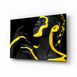 Yellow Woman glass wall art displayed above a velvet bed in a moody bedroom with rattan nightstands and brushed-brass sconces