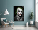 Joker glass wall art styled above a console in a hallway