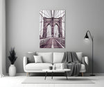 Brooklyn Bridge close-up showing pedestrian walkway and twin gothic arches in mauve mono