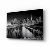 City Night glass wall art displayed above a charcoal sofa in a moody living room with walnut console and brass picture light