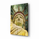The Statue of Liberty glass wall art displayed above a leather sofa in a contemporary lounge with walnut console and brass picture light