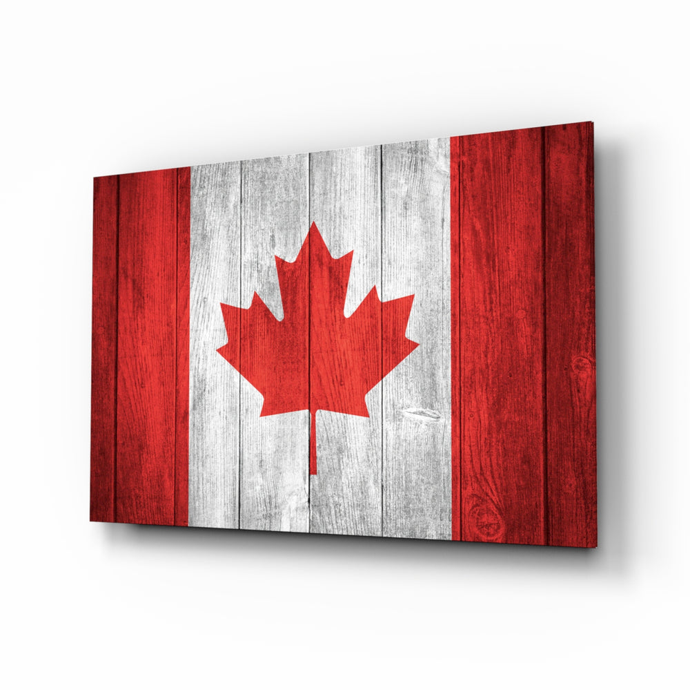 Flag of Canada glass wall art displayed above a leather chesterfield in a Canadiana lounge with reclaimed-wood console and brass picture light