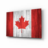 Flag of Canada glass wall art displayed above a leather chesterfield in a Canadiana lounge with reclaimed-wood console and brass picture light