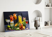 Cocktails close-up showing seven cocktails with herbs and fruit garnish on slate counter