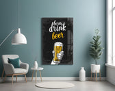 Beer glass wall art styled above a sideboard in a home bar