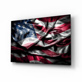 Flag of the United States glass wall art displayed above a leather chesterfield in a moody Americana lounge with reclaimed-wood console and brass picture light