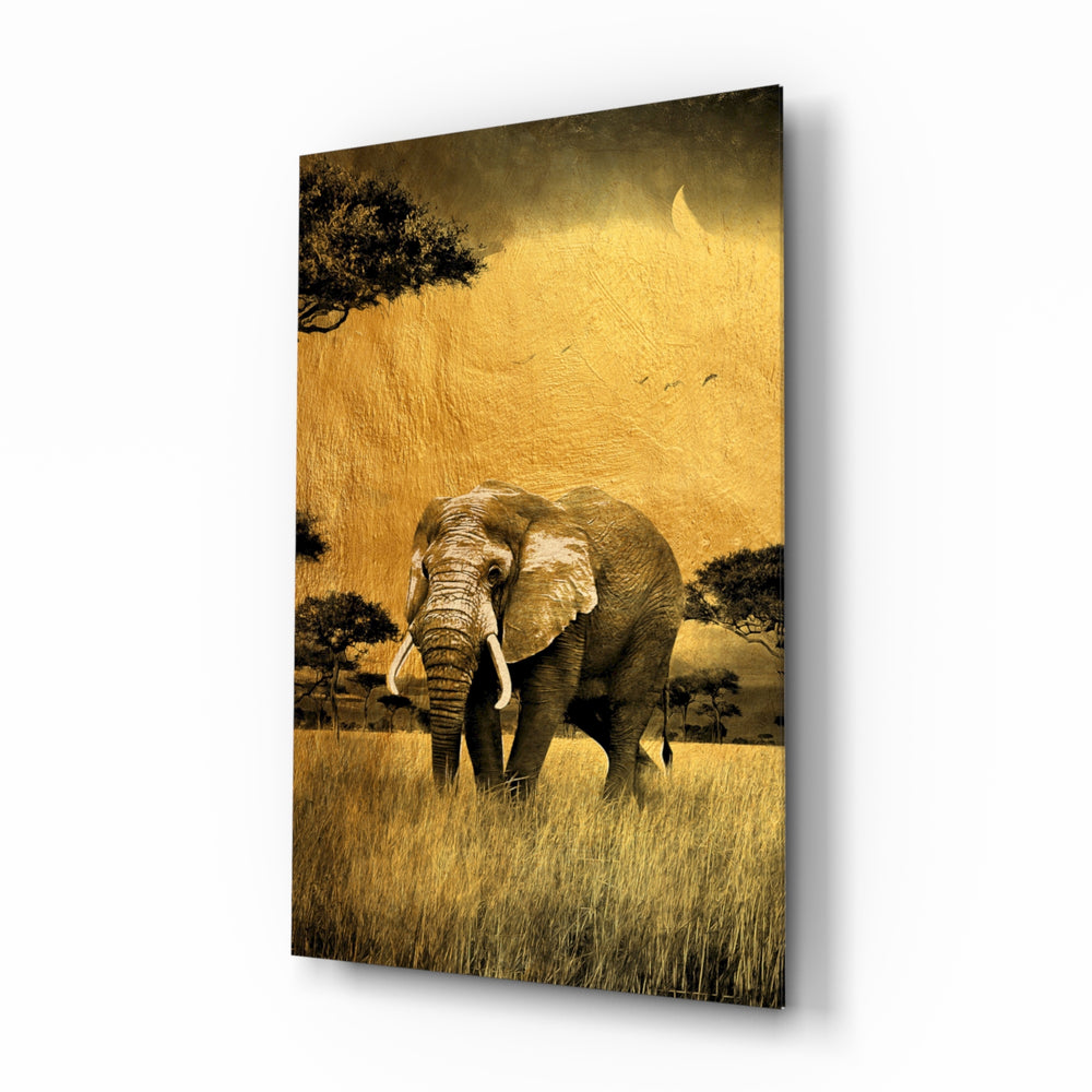 Elephant glass wall art displayed above a linen sofa in a warm safari lounge with rattan armchair and brass picture light