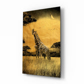 Giraffes glass wall art displayed above a linen sofa in a warm safari lounge with rattan armchair and brass picture light