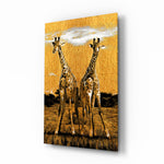 Giraffes glass wall art displayed above a walnut sideboard in a warm dining room with rattan pendants and brass picture light