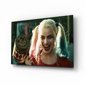 Harley Quinn glass wall art displayed above a velvet sofa in a moody teen lounge with brass arc lamp and matte-black coffee table