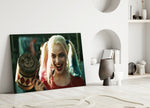 Harley Quinn close-up showing wide grin with bat over shoulder and tri-color pigtails