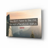 Not a Facebook Status glass wall art displayed above a linen bed in a peach bedroom with rattan nightstands and brushed-brass sconces