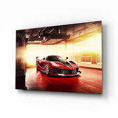 Ferrari FXX K glass wall art displayed above a leather chesterfield in a moody man cave with reclaimed-wood console and brass arc lamp