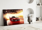 Ferrari FXX K close-up showing crimson body in sunlit pit garage with race decals