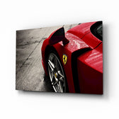 Ferrari FXX K glass wall art displayed above a leather chesterfield in a moody man cave with reclaimed-wood console and brass arc lamp