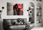 Ferrari FXX K glass wall art styled above a desk in an office