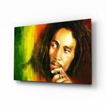 Bob Marley glass wall art displayed above a leather sofa in a moody music room with reclaimed-wood console and brass arc lamp