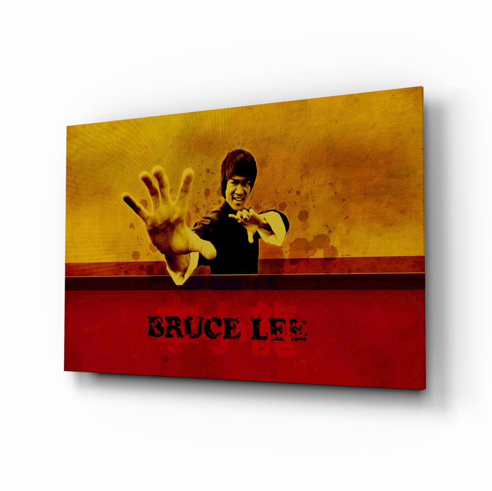 Bruce Lee glass wall art displayed above a leather chesterfield in a moody man cave with reclaimed-wood console and brass arc lamp