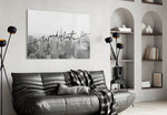 Wanderlust glass wall art styled above a desk in an office