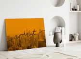 Wanderlust close-up showing flowing cursive across marigold-tinted NYC skyline