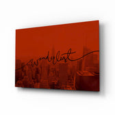 Wanderlust glass wall art displayed above a linen bed in a crimson bedroom with rattan nightstands and brushed-brass sconces