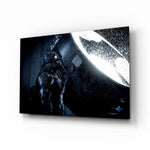 Batman Call glass wall art displayed above a black leather sectional in a moody home theater with brass arc lamp and reclaimed-wood console