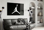 Air Jordan glass wall art styled above a console in a sneaker closet